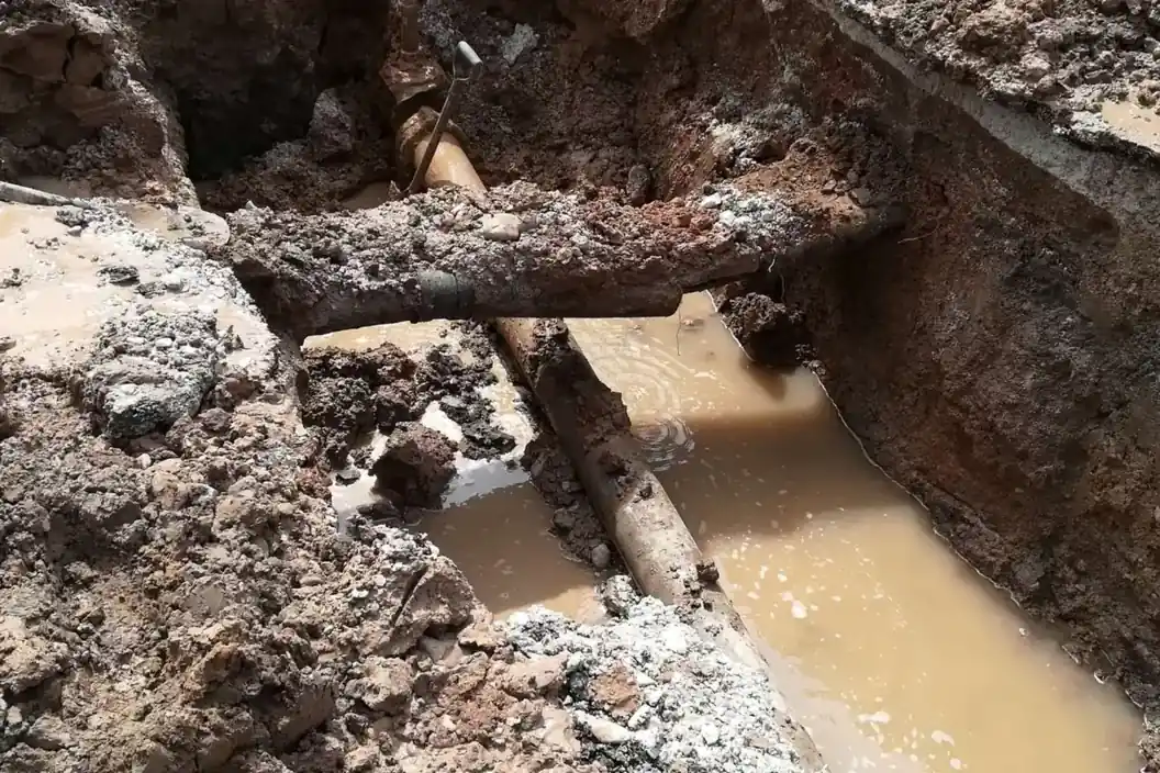 Zanja abierta con la tubería de agua a la vista tras localizar la fuga